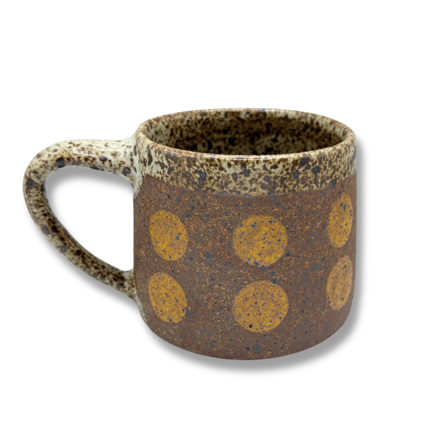 Speckled ceramic mug with yellow circle pattern and curved handle, brown base