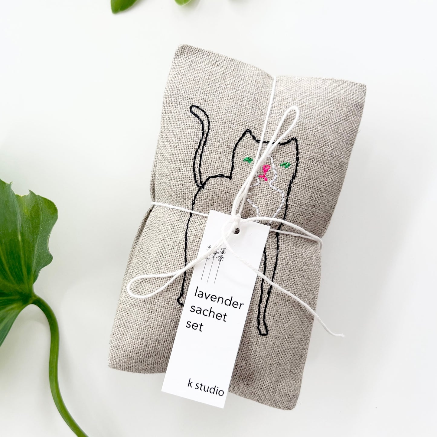 Gray cat sachet pair with lavender-scented tag, tied with ribbon
