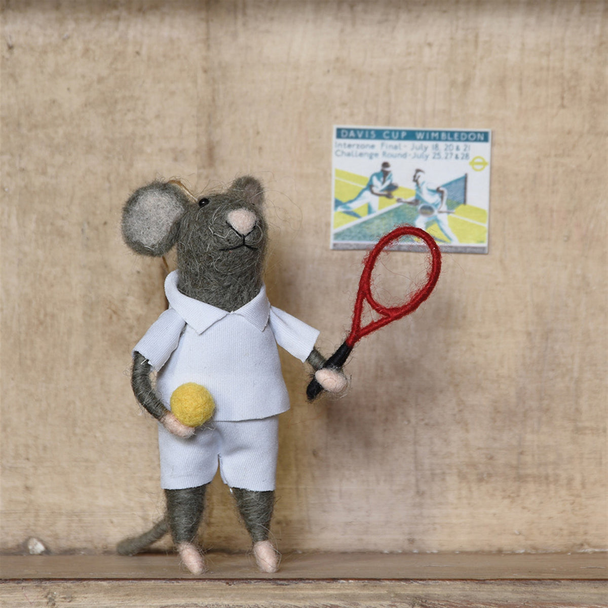 Gray felt mouse tennis player standing, white shorts and shirt, yellow ball, red racket