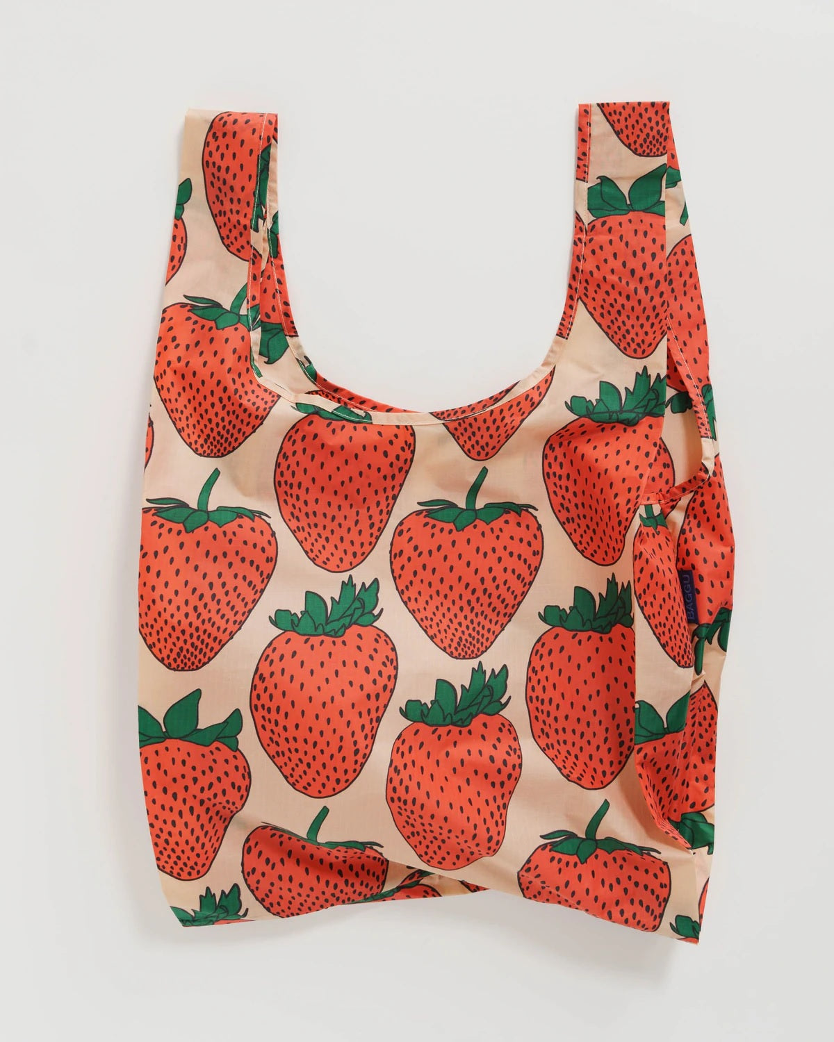 Reusable tote bag with orange strawberry print and green leaves