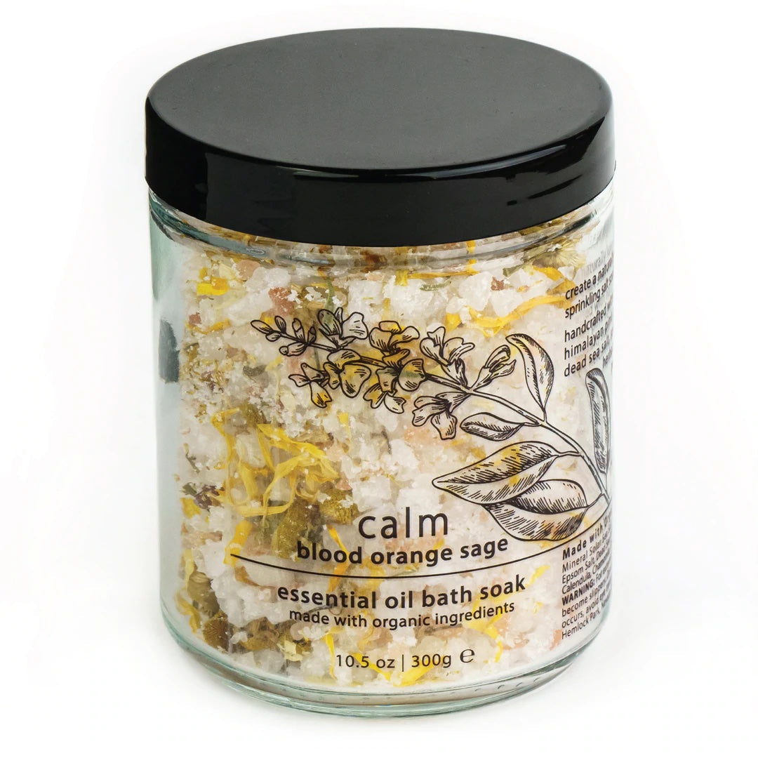 Essential oil bath soak jar with black lid, labeled Calm