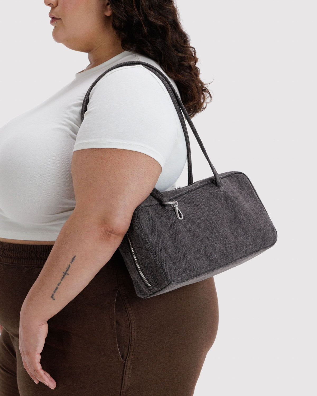 Washed black denim bowler bag, side view with zip front pocket