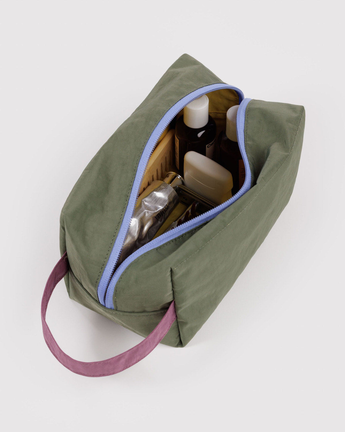 Olive dopp kit with purple strap and light-blue piping, open top with interior slots