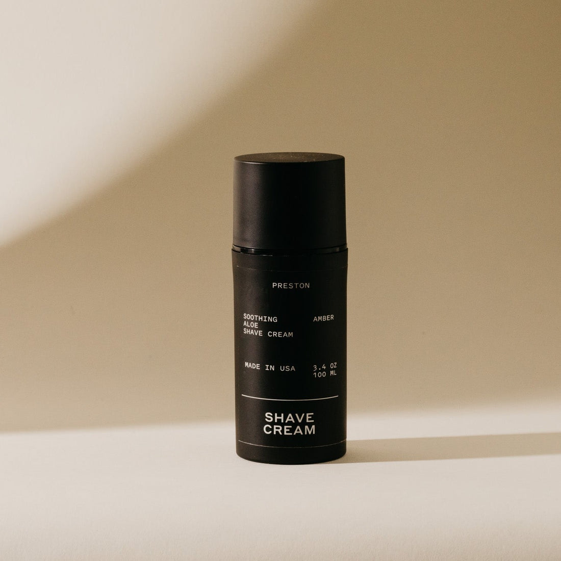 Amber shave cream in black aerosol canister with flip-top lid, Preston label