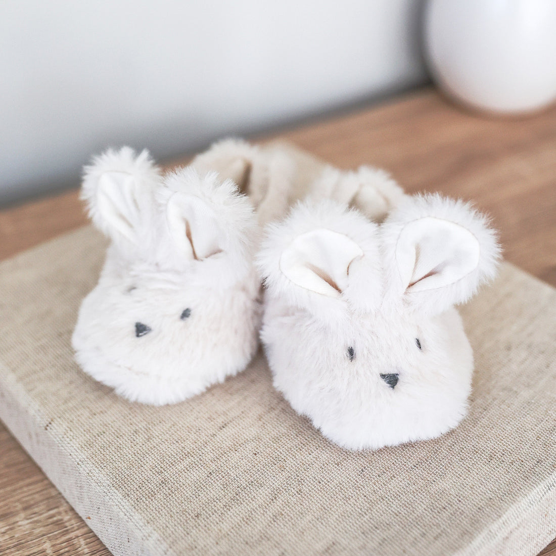 Ivory plush bunny booties with floppy ears and embroidered face, closed toe slippers