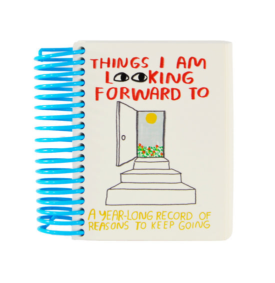Inspirational journal with blue spiral binding and illustrated cover text