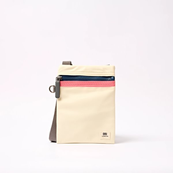 Cream recycled nylon pocket crossbody bag with top zipper, teal inner panel, gray strap