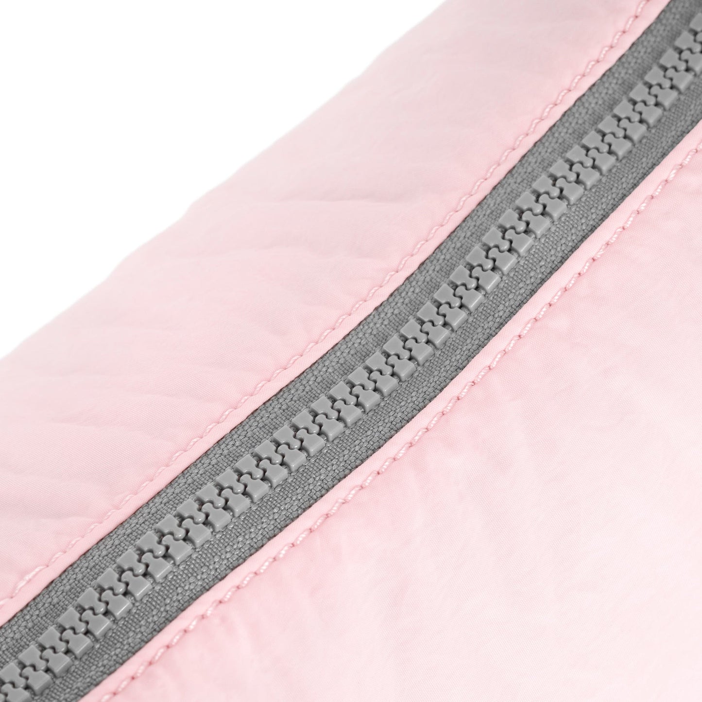 Seashell half-moon bag zip and seam detail with pink fabric and gray zipper.