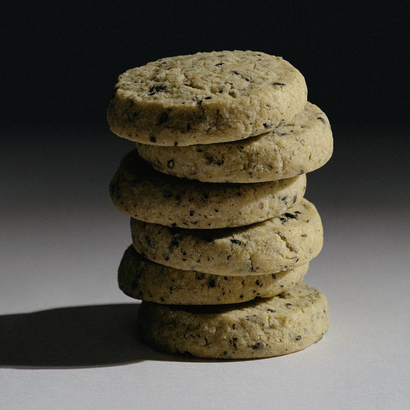 Stack of dark sesame shortbread cookies in a close-up