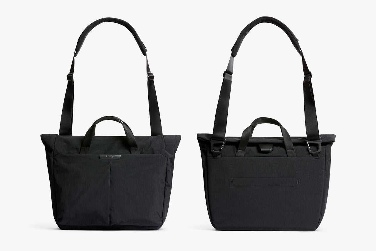 Black tote-style messenger bag with top handles and adjustable shoulder strap.