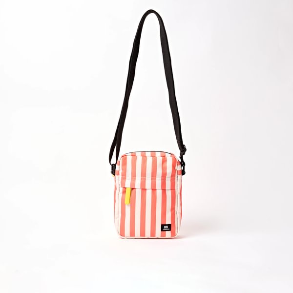 Canvas crossbody bag with coral-and-white stripes, zip top, and adjustable black strap
