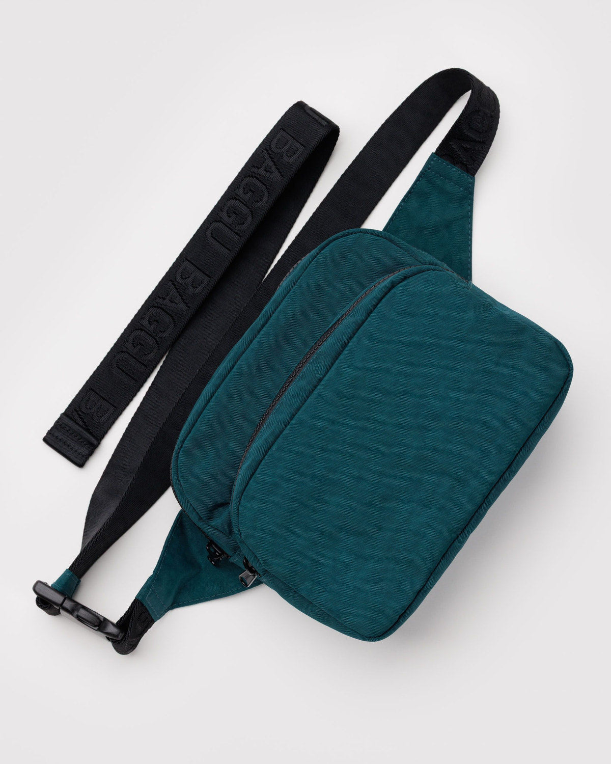 Teal waist bag with front zip pocket, top zipper, and adjustable strap