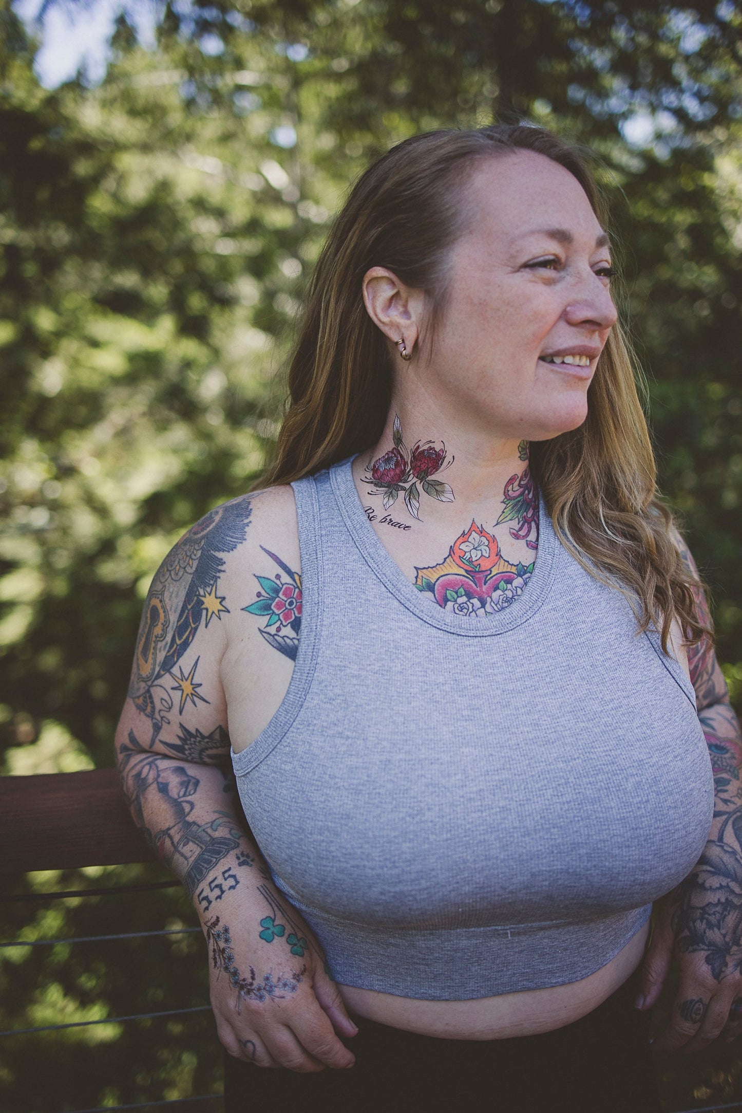 Temporary floral tattoos on neck and left arm with red and blue petals