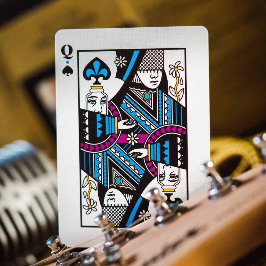 Queen of spades playing card with blue, gold, and white illustrated figures