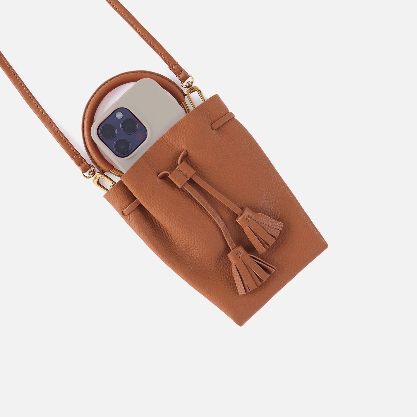Warm honey textured phone crossbody bag with phone slot and tassel detail.