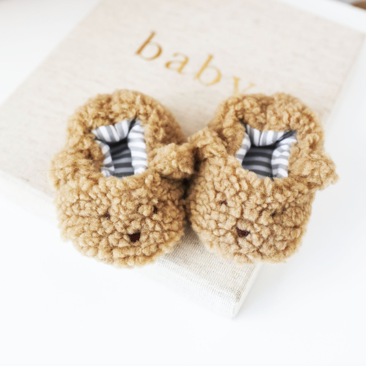 Caramel sherpa bear booties with tan fuzzy outer and striped inner toe