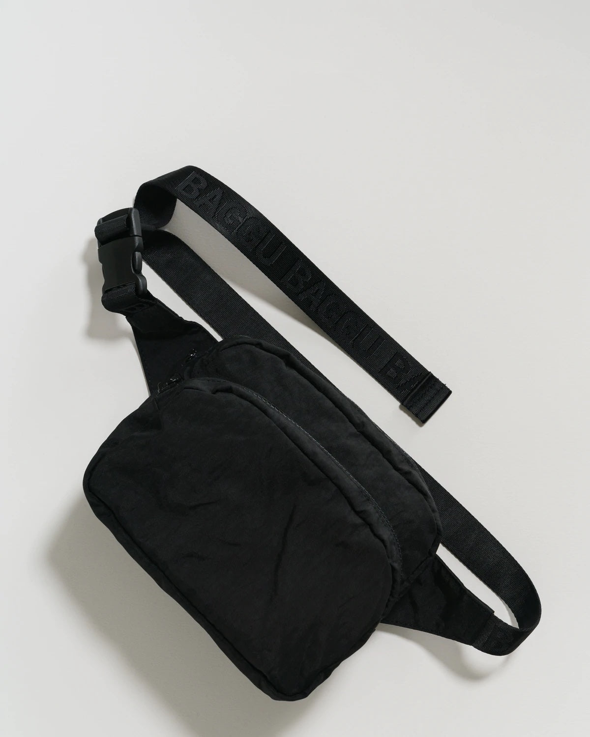 Black waist fanny pack with front zip pocket, top zipper, and adjustable strap