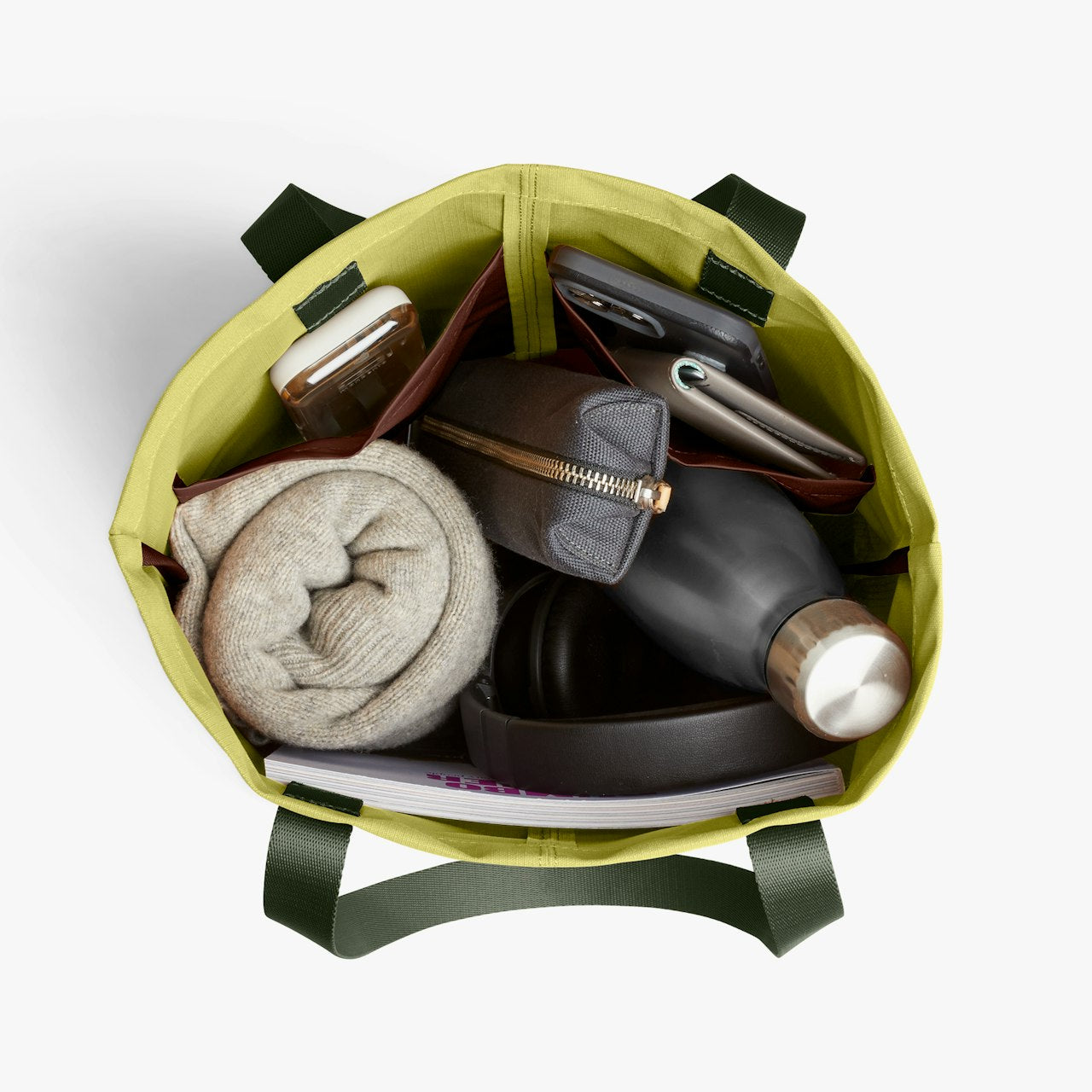 City tote bag interior with bottle, folded cloth, and card holders inside the open top.