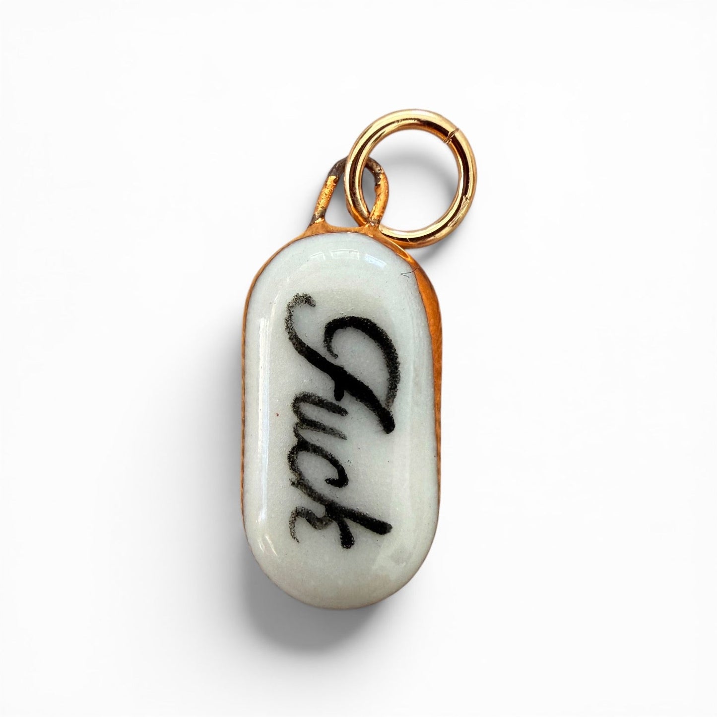 Porcelain charm, black "fuck" lettering, gold ring bail