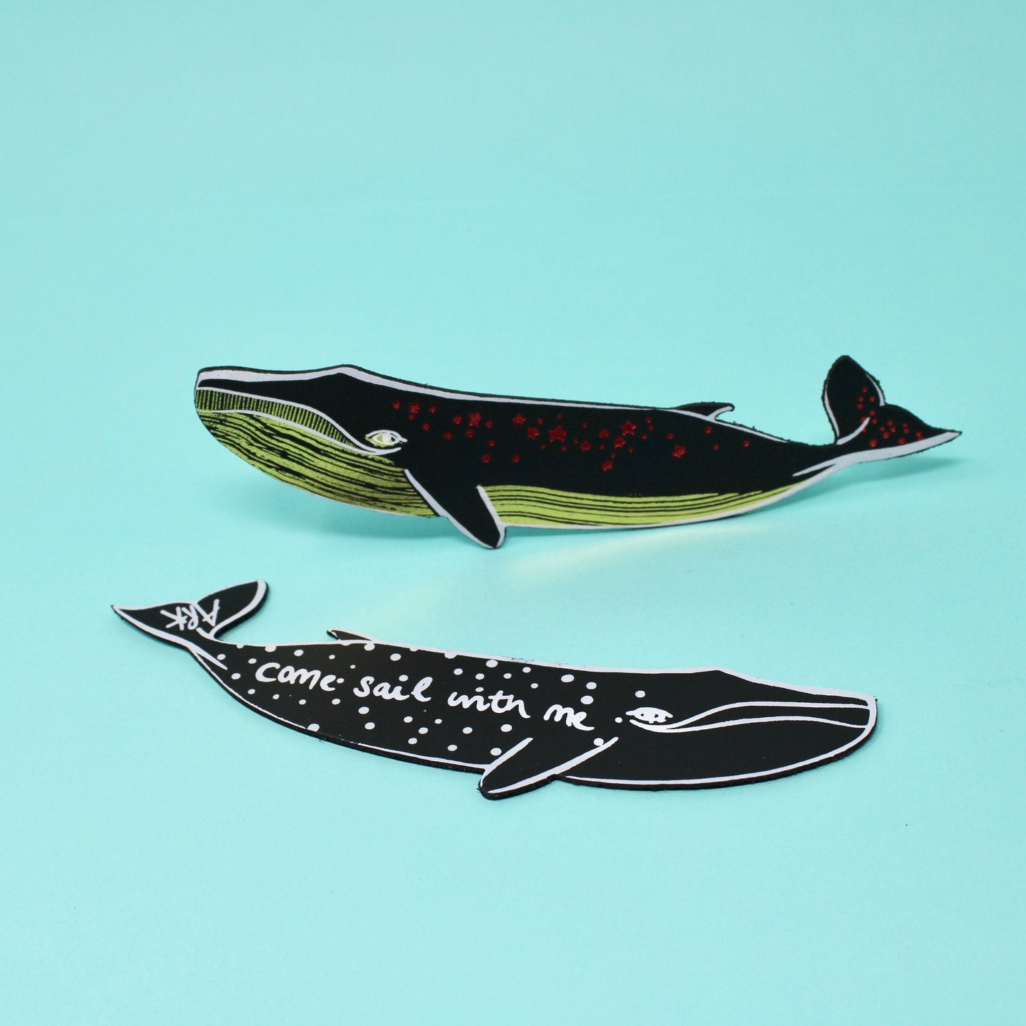 Dark whale leather bookmark with green underside and red speckled details