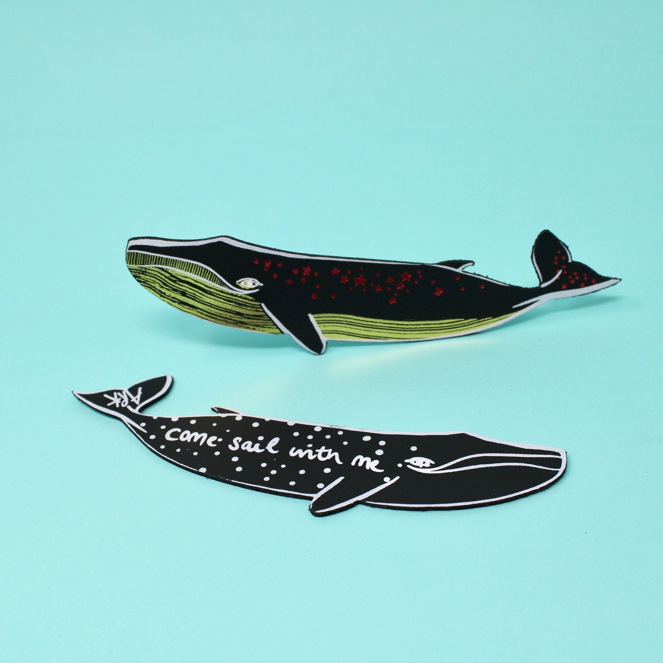 Dark whale leather bookmark with green underside and red speckled details