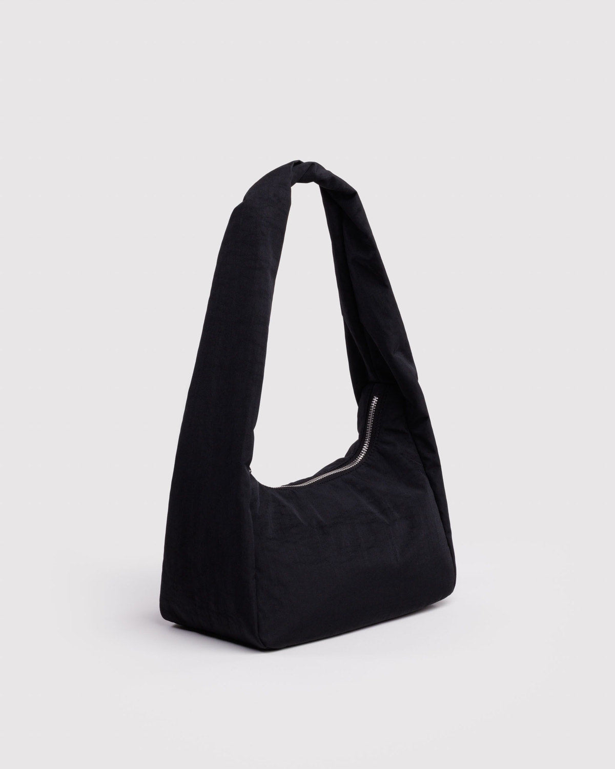 Black meringue-style nylon bag with curved body and top handle