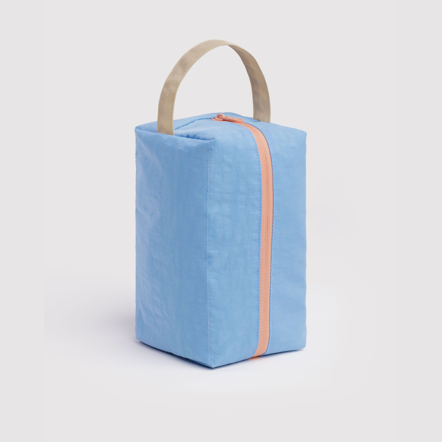 Light blue dopp kit with coral zipper and beige carry handle