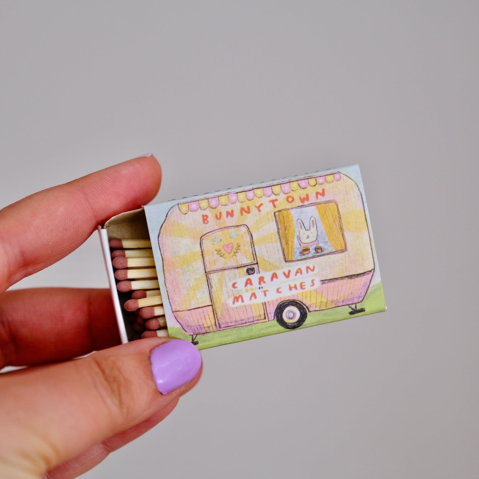 Caravan matchbook with colorful caravan graphic; open box of wooden matches