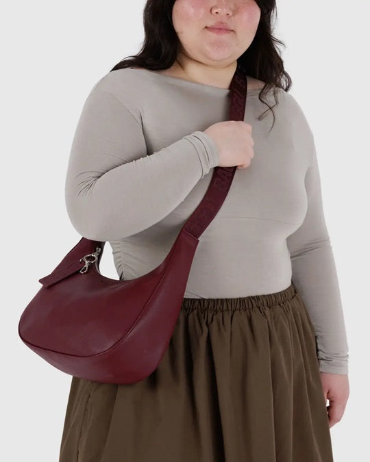 Medium recycled leather crescent bag in burgundy with zip top and hanging strap