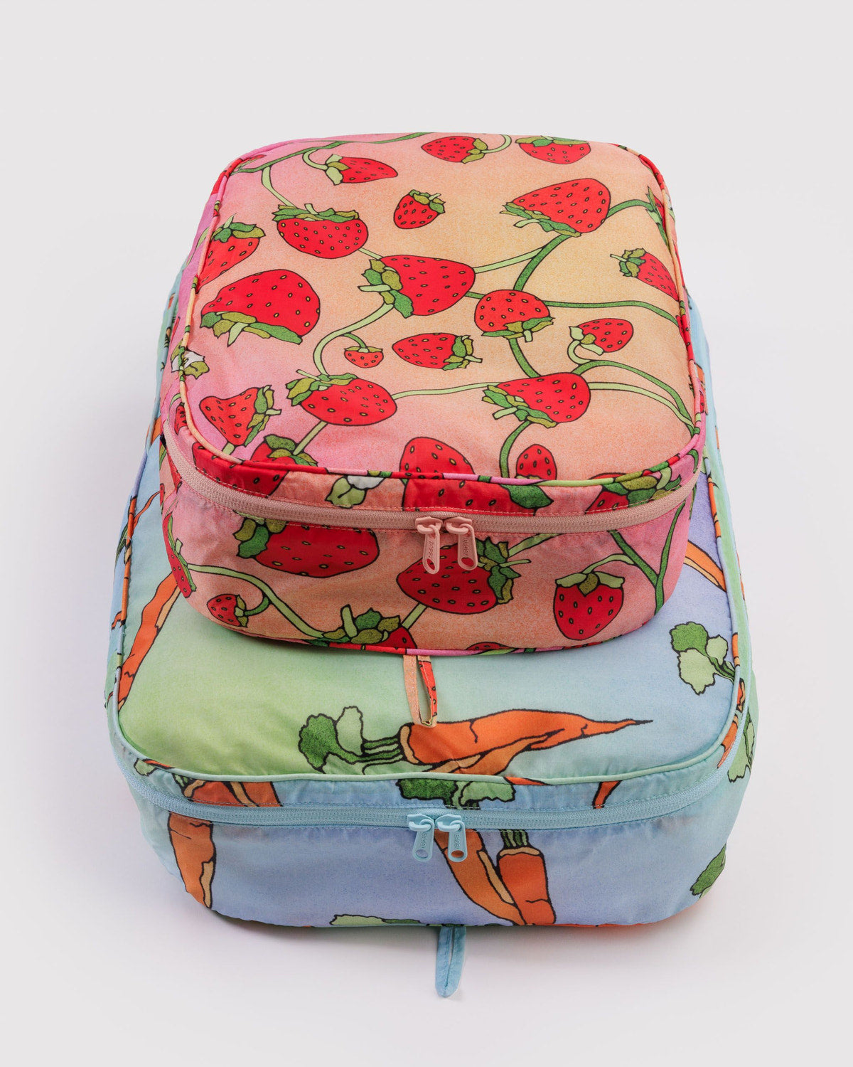 Large packing cube set with strawberry, carrot, and cactus prints; zip closures and handle straps