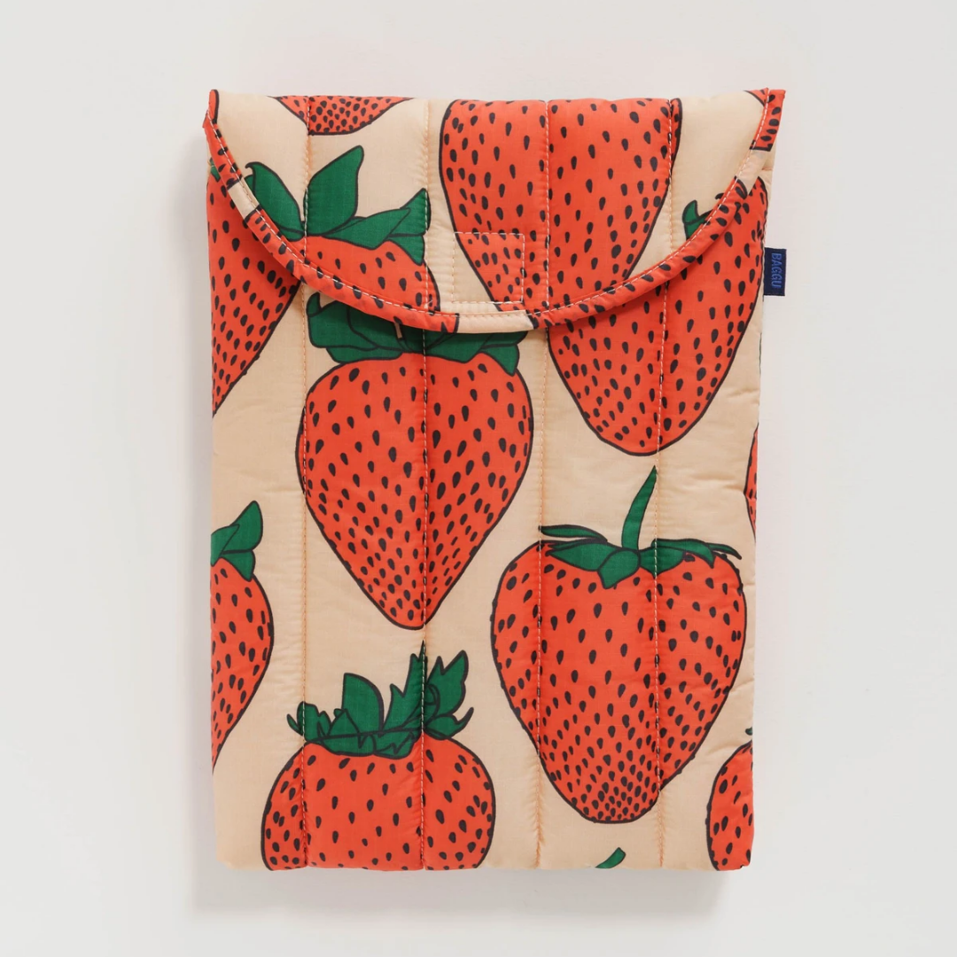Beige puffy 13"/14" laptop sleeve with red strawberry print and gathered top flap.