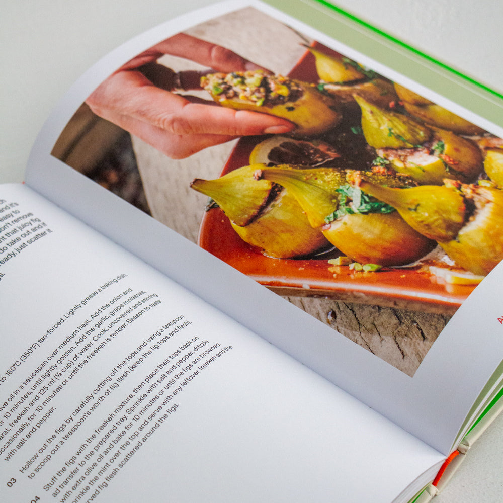 Salad cookbook open to a page with a baked vegetable food photo