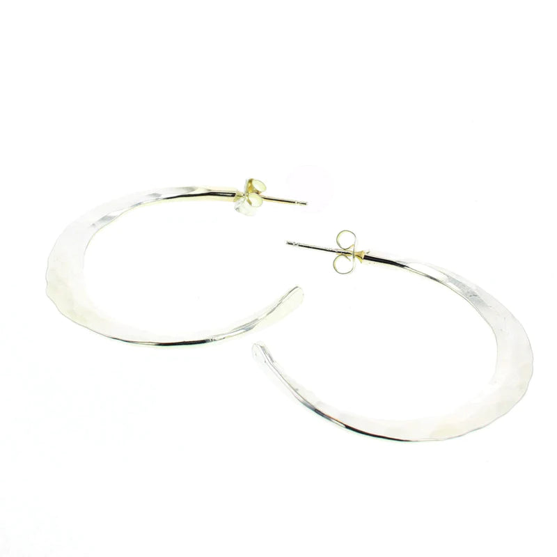 Silver statement hoop earrings with smooth, reflective oval shape