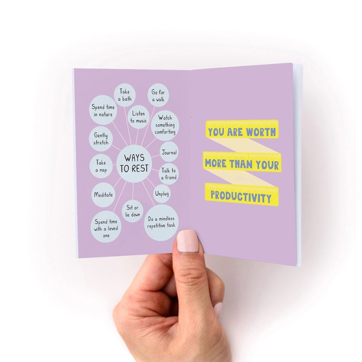 Opened purple zine with multiple labeled sections and yellow quote and productivity stickers