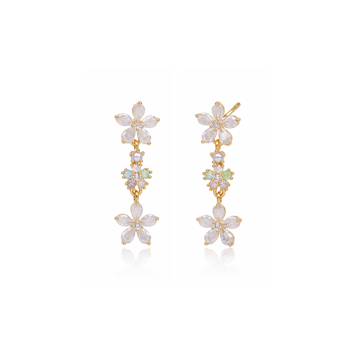 White flower drop earrings with three stacked dangling blooms and gold-tone hooks