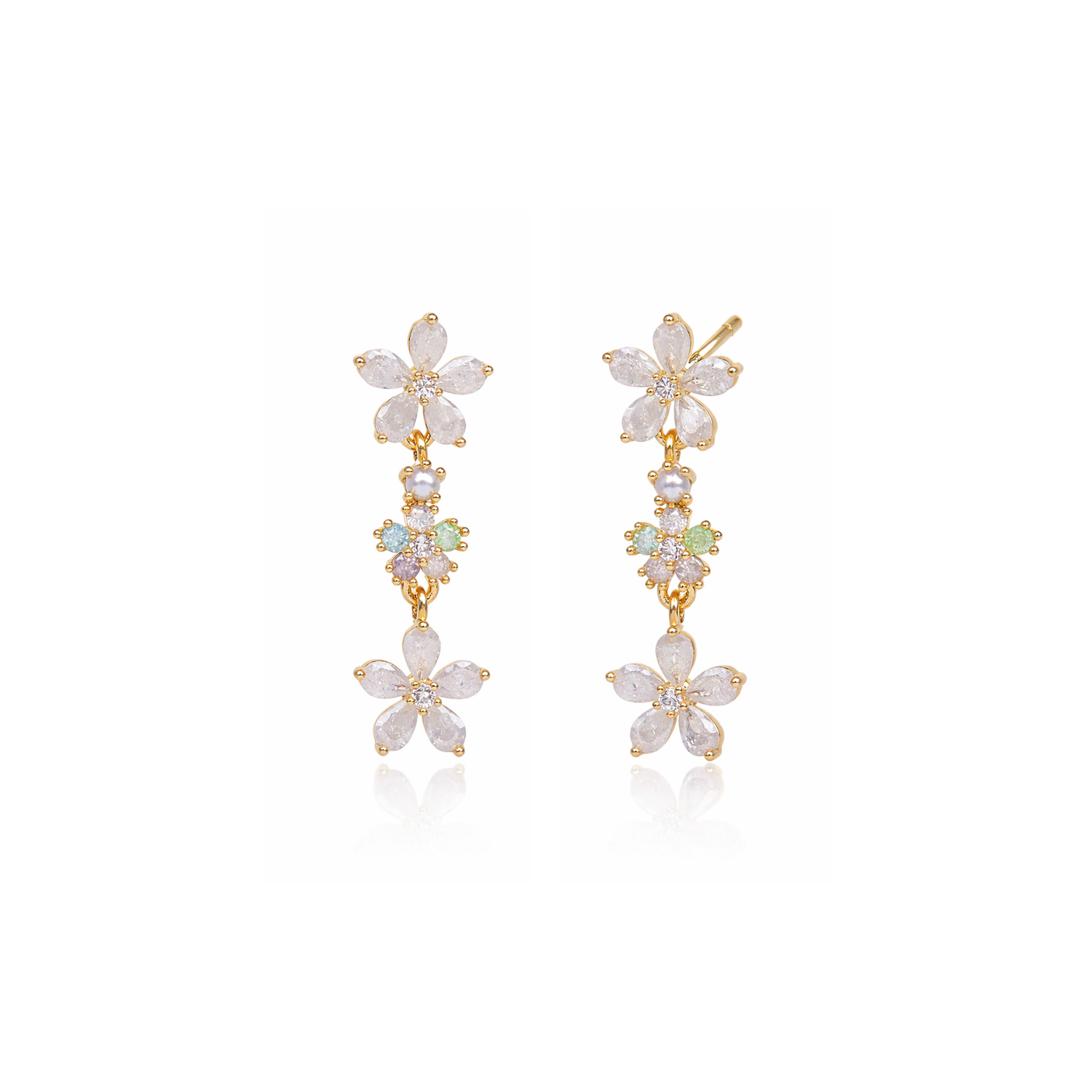 White flower drop earrings with three stacked dangling blooms and gold-tone hooks