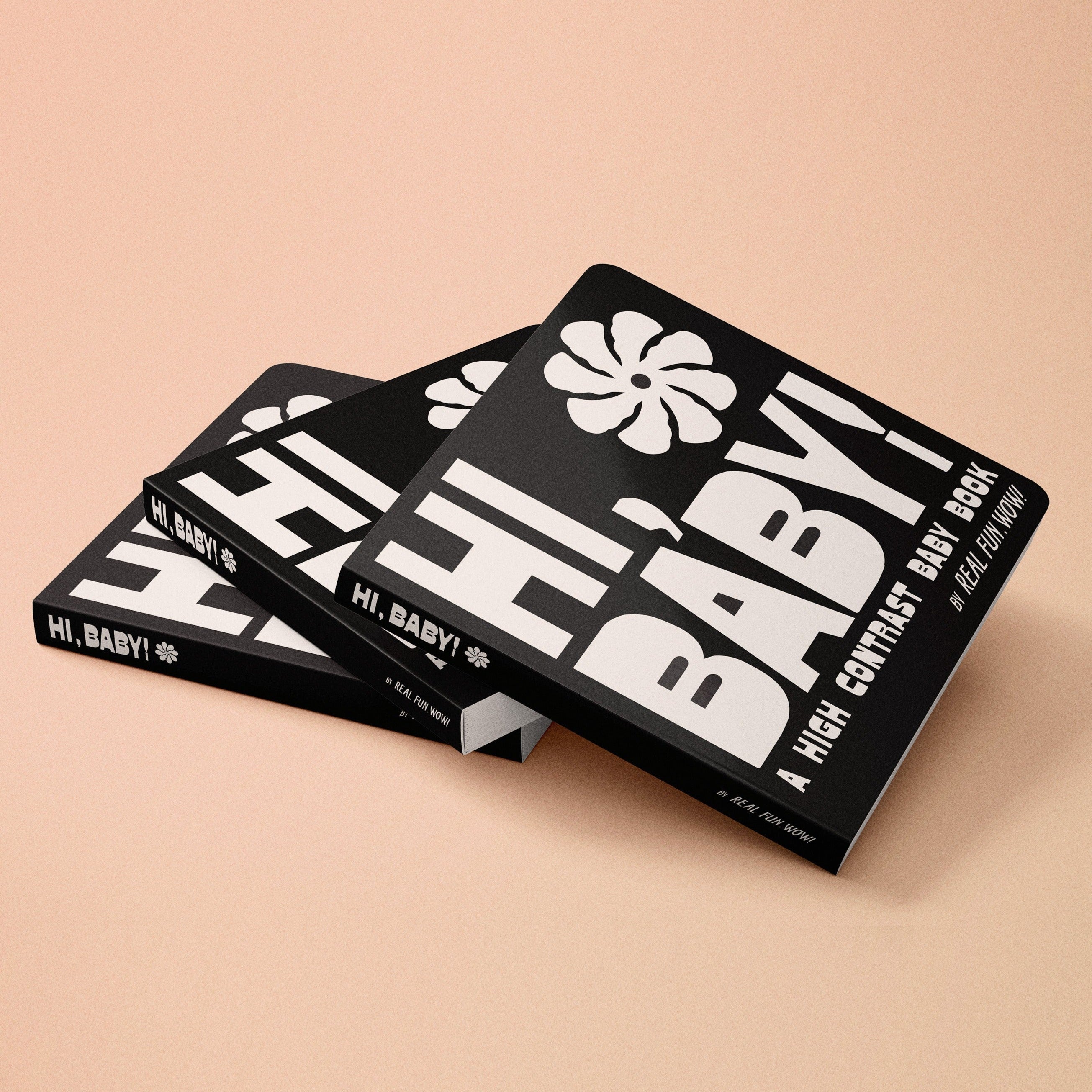 High-contrast baby board book, black cover with bold white flower and stripe design