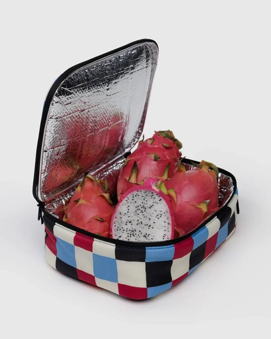 Open checkered lunch bag with foil lining and fruit inside, zipper and strap visible.