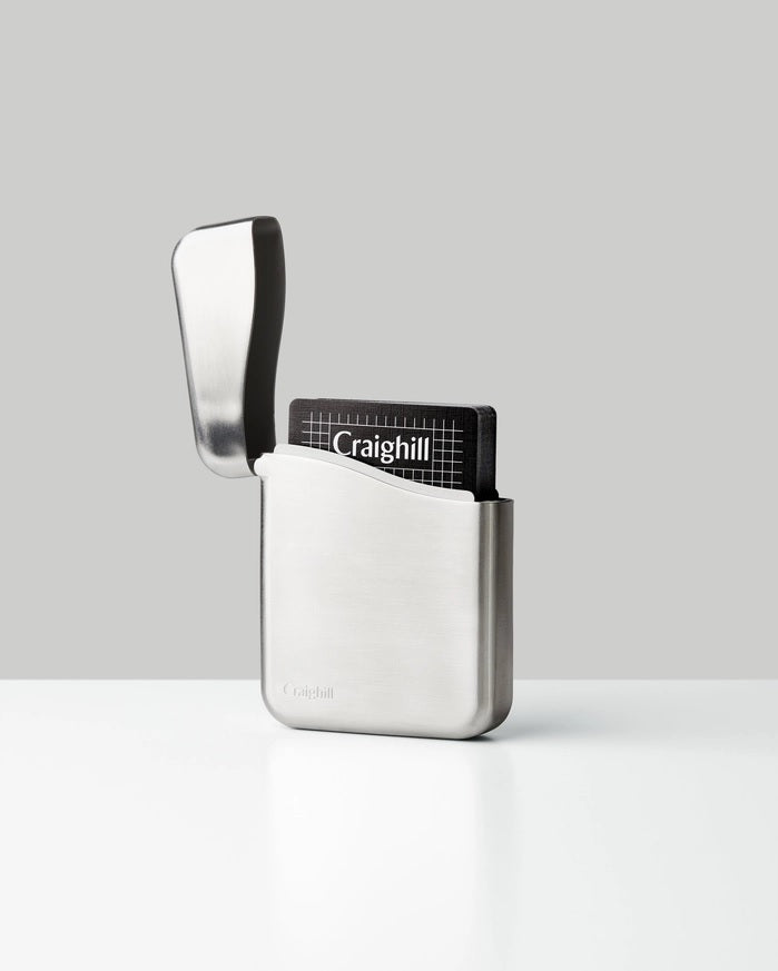 Stainless steel playing card case, front pocket open with Craighill card holder visible