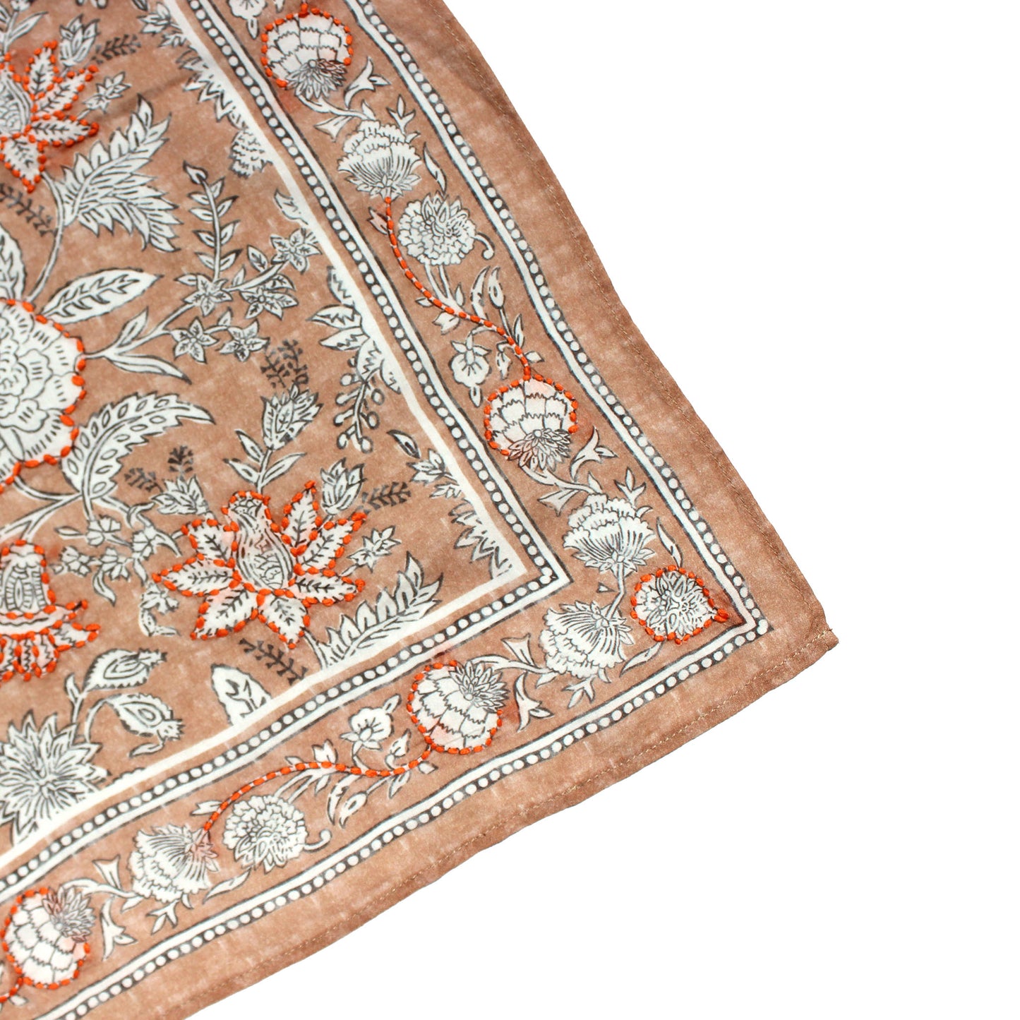 Tan embroidered bandana corner with floral motif, orange accents, and white border trim