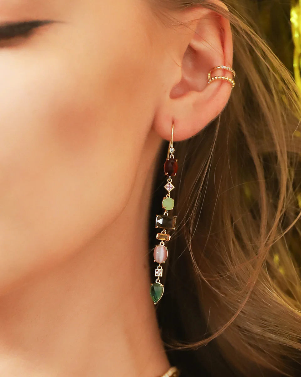 Gold-tone stacked drop earrings with multicolor stones, worn on model ear