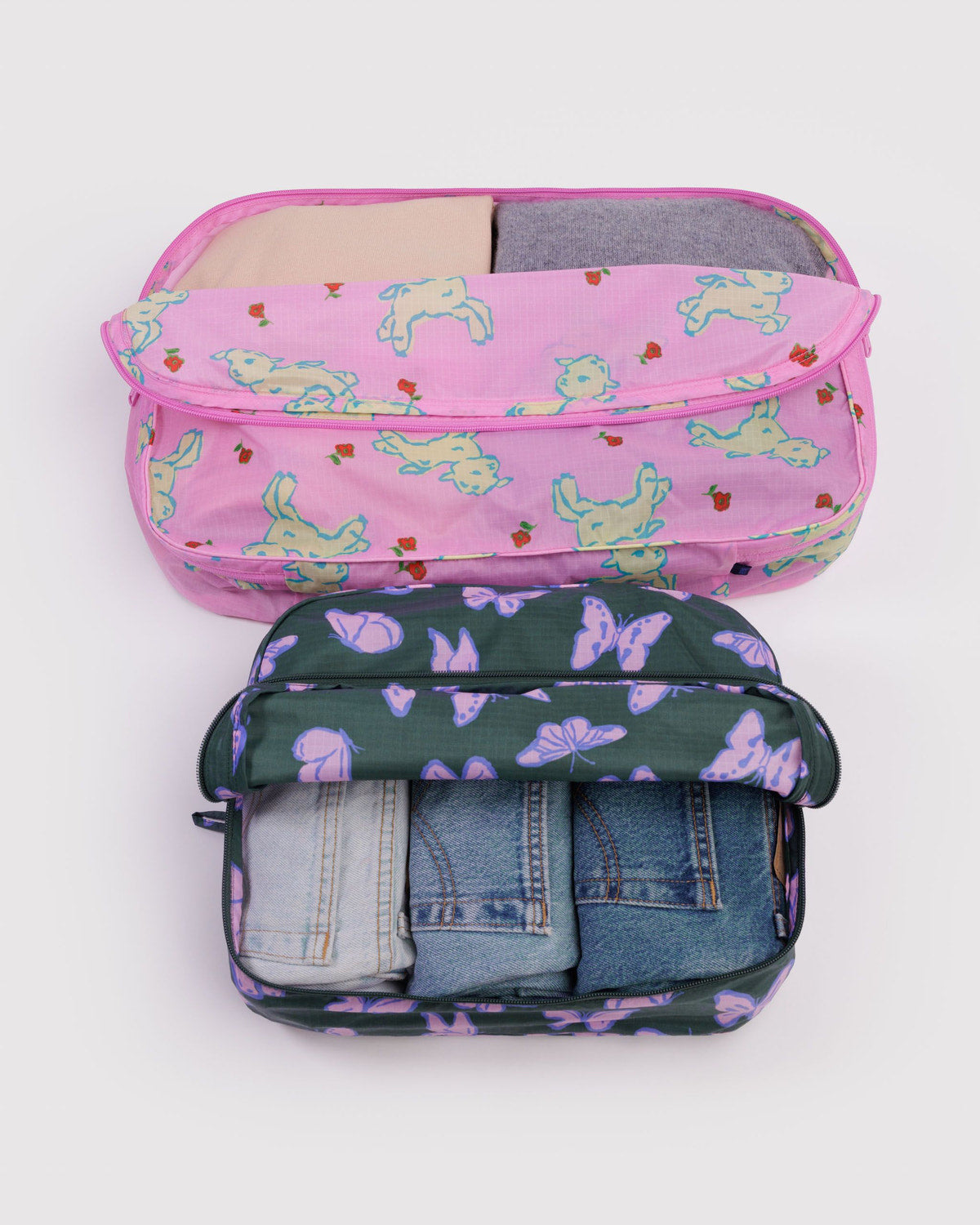 Large packing cube set with pink unicorn print and dark purple animal print, zipped