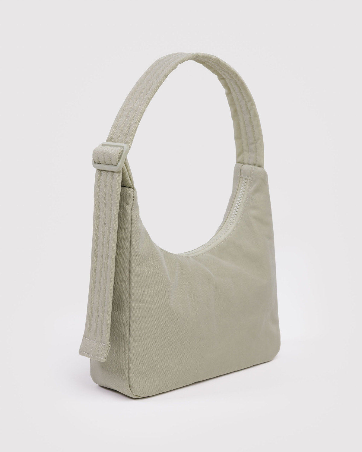 Pale green mini nylon shoulder bag with zip top and long handle strap