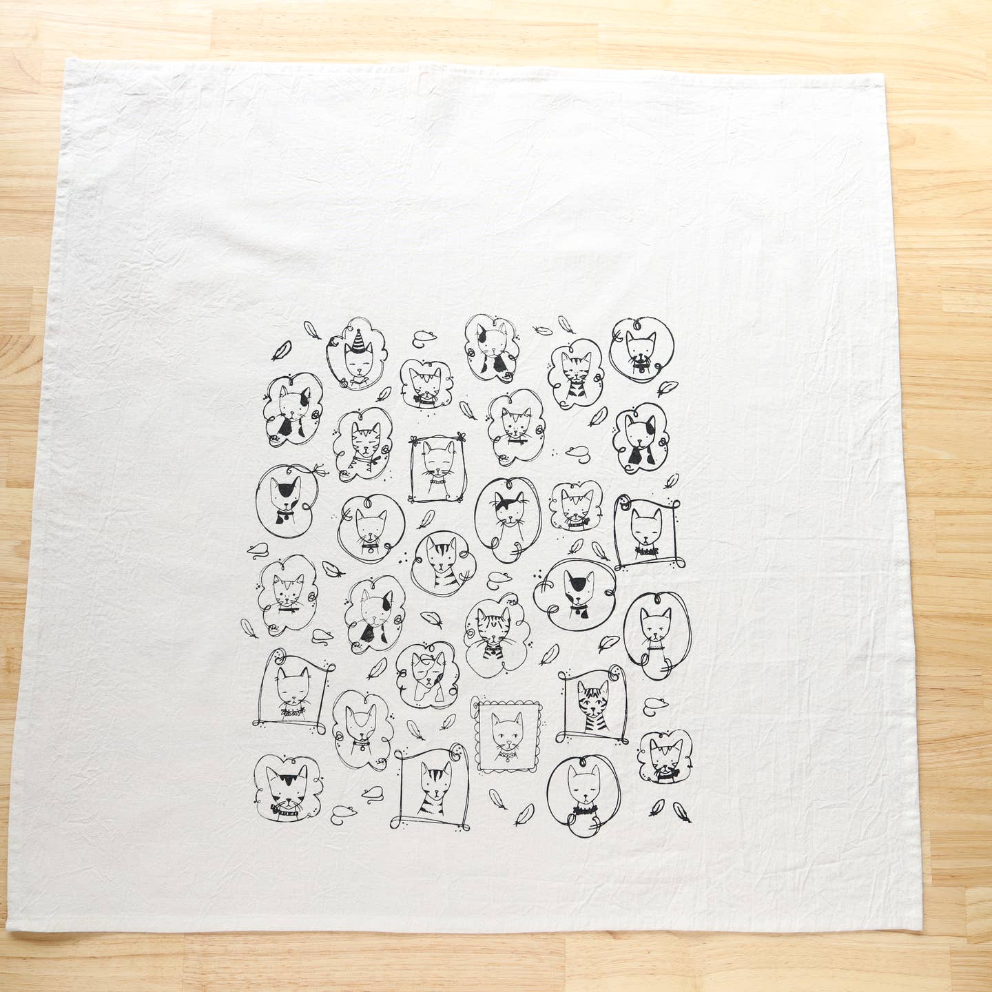 White cat kitchen tea towel with dense centered line-art cat faces and bodies