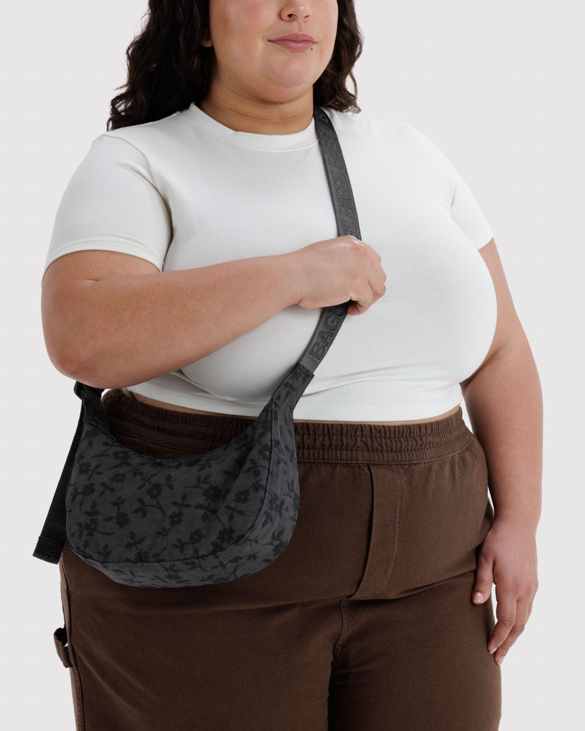 Small nylon crescent bag, black worn crossbody with adjustable strap