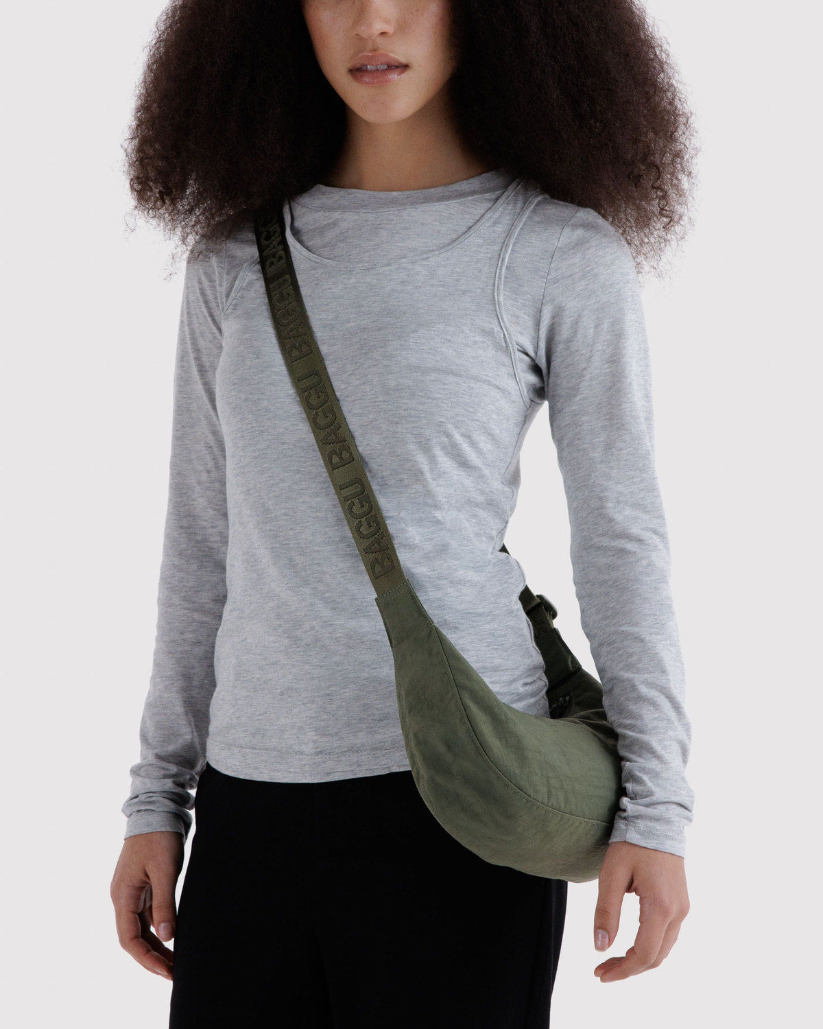 Small nylon crescent bag, olive green worn crossbody with adjustable strap