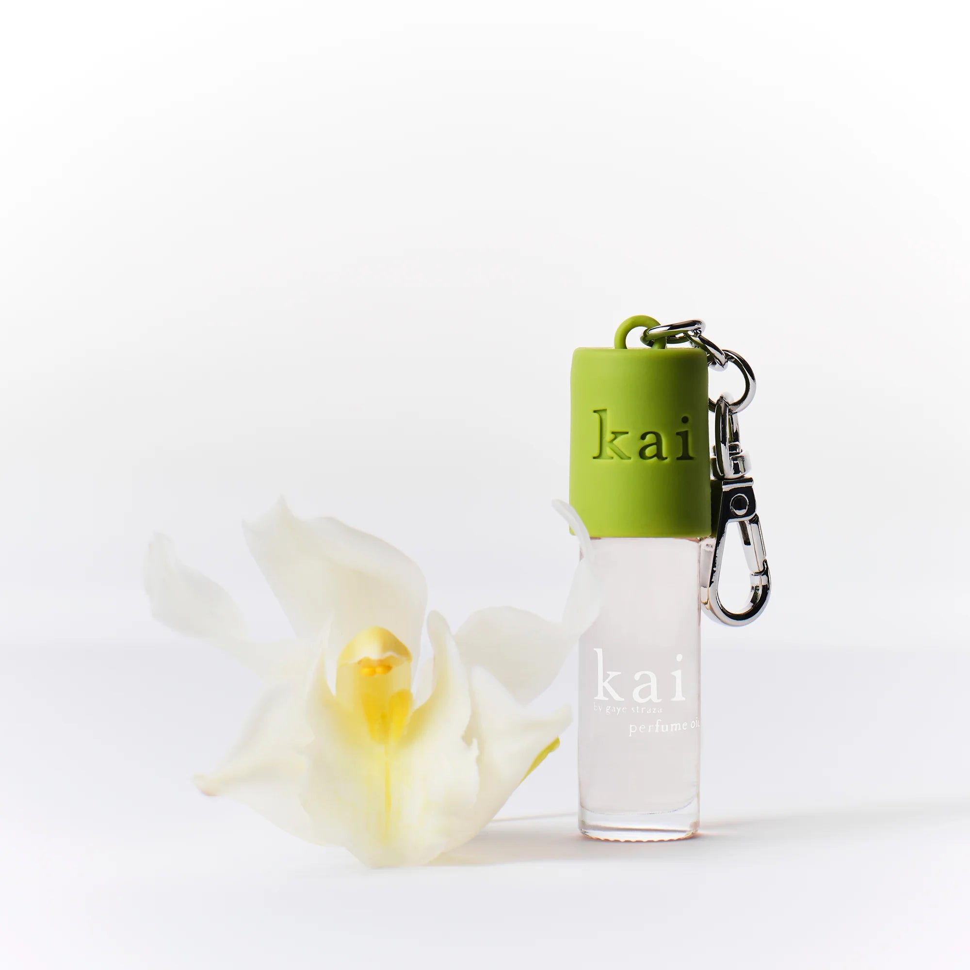 Green Kai keychain with metal clip and ring, branded kai on front