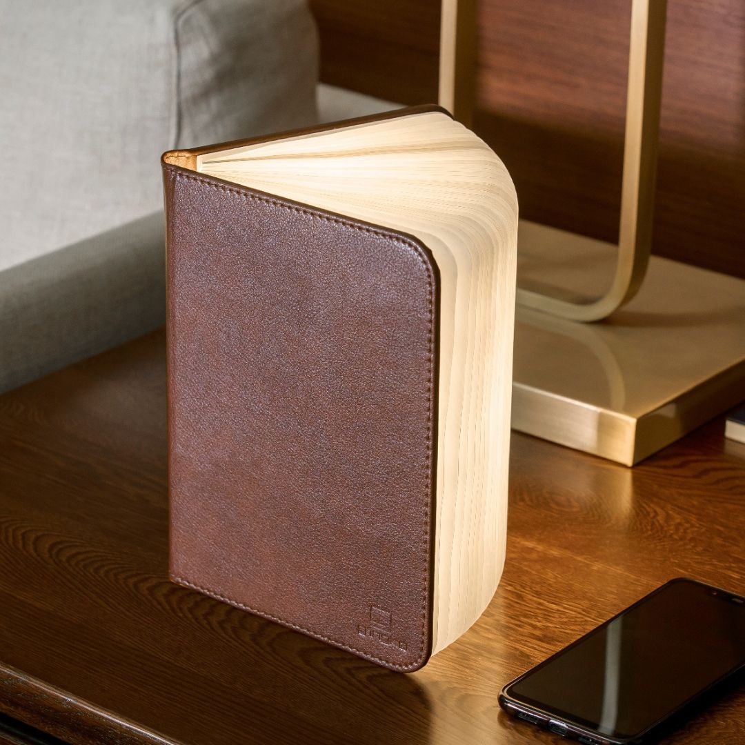 Brown leather smart booklight with LED light illuminating open book pages