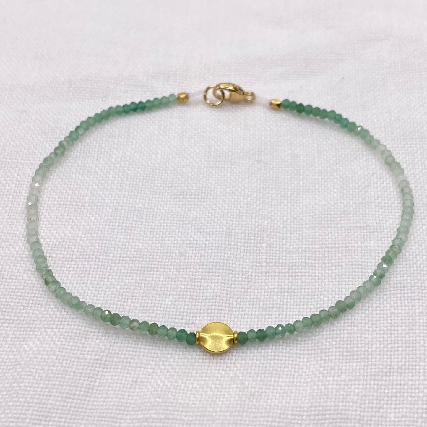 Aventurine bead bracelet with 18k gold clasp and small green faceted beads
