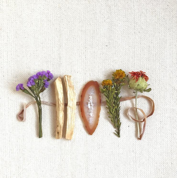 Wood Creek Palo Santo bundle set with dried flowers, light wood sticks, and an oval piece